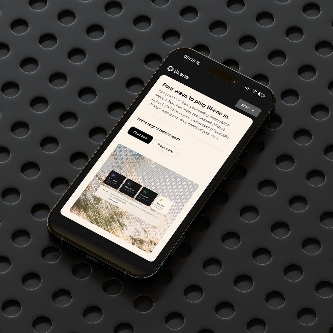 Skene's mobile website displayed on a phone resting on perforated black metal.