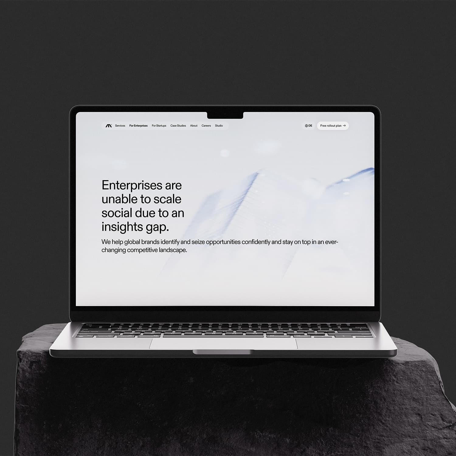 Moonbase's social data insights page displayed on a laptop on a dark stone pedestal.